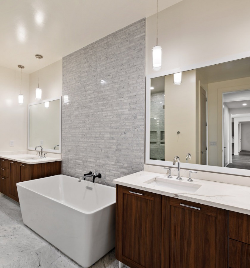 Bathroom with large, stand-alone tub and double-sided vanities